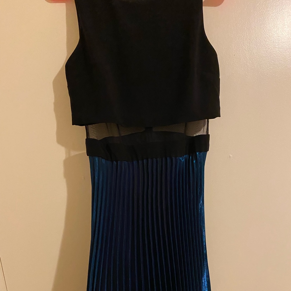 Black crop top with mesh material and flowy teal bottom. Very flattering!
